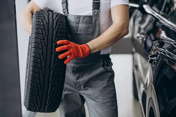 mechanic-changing-tires-car-service.webp